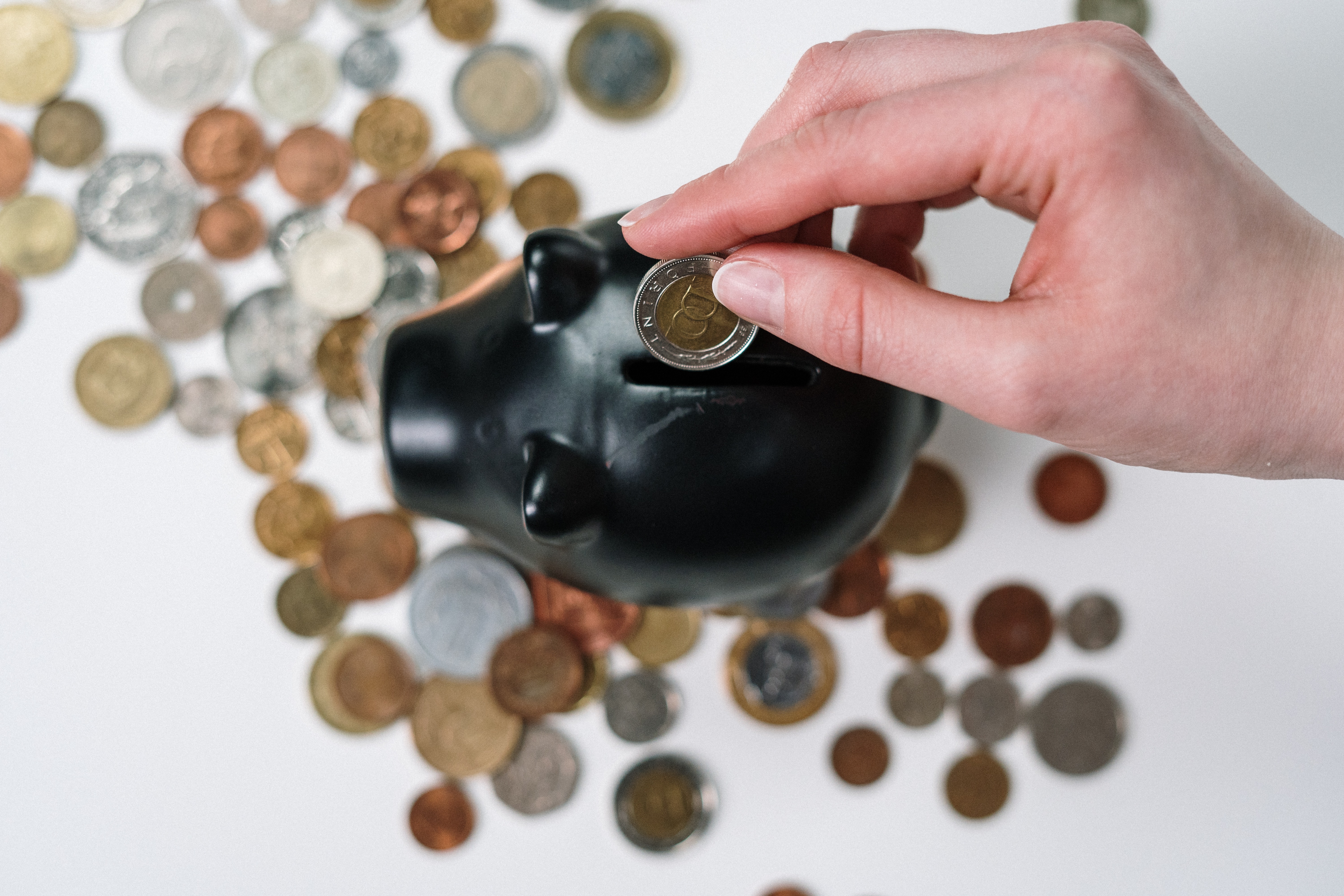 Putting coins in piggy bank